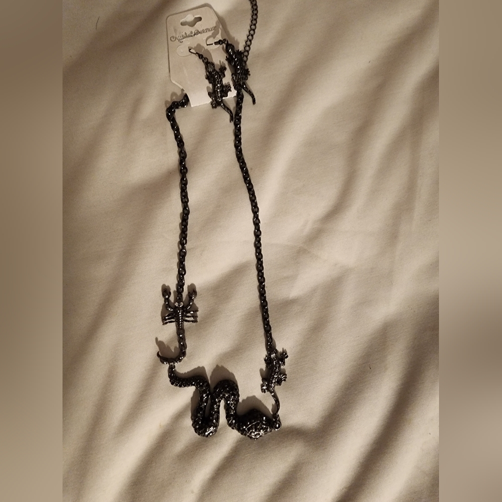 A cool necklace with snake,scorpion, and lizard